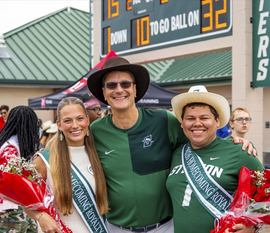 Homecoming king and queen with university president