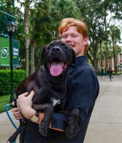 Blake Christensen holding his pet Waffles