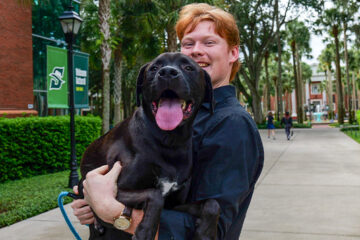 Blake Christensen holding his pet Waffles